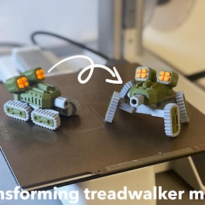 Peut inclure: Un jouet de méca marcheur transformable vert olive et gris. Le jouet a une conception de type char avec des chenilles et des lanceurs de missiles. Le texte "transforming treadwalker mech" est au bas de l'image.