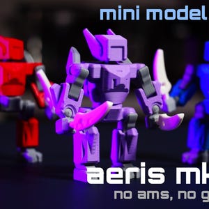 May include: Three colorful mini model kits of robots. The robots are red, purple, and blue, each holding a white blade. The text "mini model kit", "aeris mk I", and "no ams, no glue" are displayed in white.