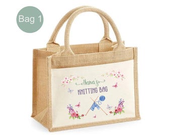 May include: A natural hessian tote bag with a white fabric panel featuring a floral design and the text "Nana's Knitting Bag" with a pair of knitting needles and yarn.