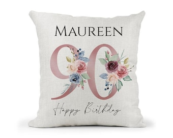 May include: A white pillow with a pink floral design and the text "MAUREEN 90 Happy Birthday".