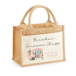 May include: A beige jute tote bag with a white canvas insert. The canvas insert features a pink camper van with a green awning and the text "Brenda's Caravan Stuff" and "Time to relax and unwind".