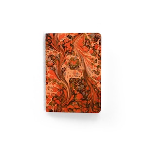 May include: A rectangular journal with a marbled cover. The cover features a swirling pattern of orange, brown, and gray colors on a peach background. The journal is set against a white background.