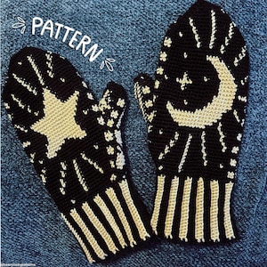 May include: A pair of black and cream crocheted mittens featuring a celestial design. One mitten displays a large star, while the other shows a crescent moon. Both have striped cuffs and the word PATTERN written in white script above them.