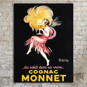 Vintage Advertising Poster for Cognac Monnet from Transit Design. The poster features a woman in a red dress with yellow hair, holding a glass of cognac. The text on the poster reads '...du soleil dans un verre... COGNAC MONNET'. The poster has a black background.
