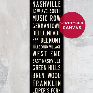 May include: Black and white sign with the text "NASHVILLE" and a list of neighborhoods in Nashville, Tennessee. The sign is on a stretched canvas.