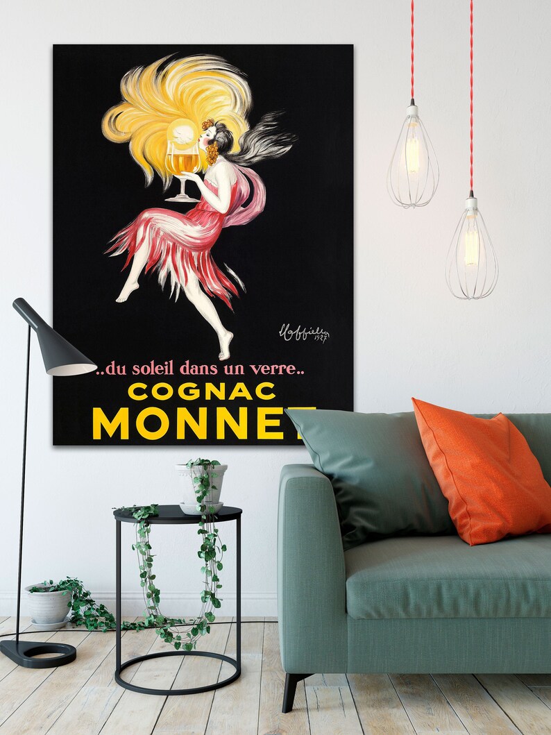 A vintage poster advertising Cognac Monnet from Transit Design. The canvas poster reads '...du soleil dans un verre... COGNAC MONNET.'