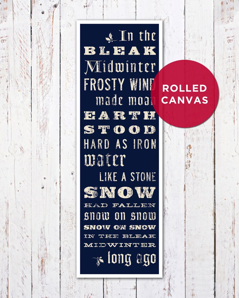May include: A navy blue rolled canvas print with white text. The text reads "In the Bleak Midwinter" and other lines from the poem. A red circle with the words "ROLLED CANVAS" is on the right side.