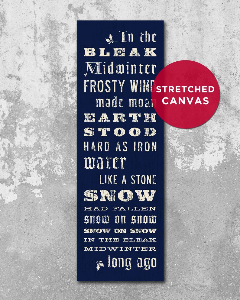 May include: A navy blue stretched canvas wall art print with white text. The text reads "In the Bleak Midwinter" and other lines from the poem. A red circle with "Stretched Canvas" is in the corner.