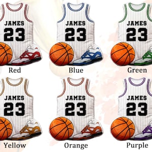 May include: A collection of basketball-themed designs featuring jerseys, basketballs, and sneakers. Each design includes a jersey with the name "JAMES" and the number "23", paired with a basketball and matching sneakers in various color schemes: red, blue, green, yellow, orange, and purple.