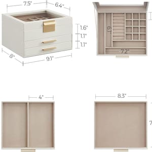 May include: A white jewellery box with three drawers and a top compartment. The box measures 23.1 cm wide, 20.3 cm deep, and 13.5 cm tall. The top compartment has a clear lid and the drawers have gold-coloured handles.