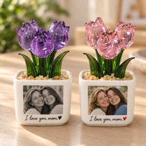 May include: Two square white ceramic planters containing glass tulips in purple and pink. Each planter features a black and white photograph of two smiling people and the printed text "I love you, mom." with a small heart icon.