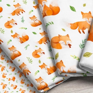 Four fabric print scales featuring white fabric with a pattern of bright orange watercolor foxes with scattered green foliage.
