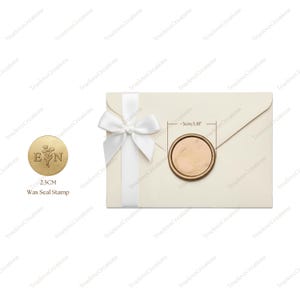 May include: An ivory envelope with a white ribbon and a gold wax seal. The wax seal is approximately 3cm in diameter and features the letters "E" and "N" with floral accents. A separate 2.5cm wax seal stamp is also shown.