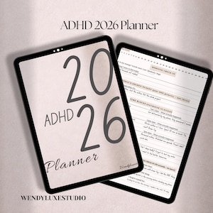 May include: Two black tablets displaying an "ADHD 2026 Planner". One tablet shows the cover with large numbers and text, the other shows a planner layout with sections for notes and scheduling. The background is a light beige.