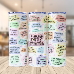 May include: Three white tumblers with colorful designs and positive affirmations for teachers. The tumblers feature phrases like "Teacher Daily Affirmations", "I am an Amazing Teacher", and "I Handle My School Day With Ease".