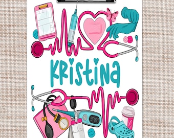 May include: A white clipboard with a pink and blue medical theme. The clipboard has a heart with a bandage, a stethoscope, a syringe, a thermometer, and a blood pressure cuff. The name "Kristina" is written in blue letters.
