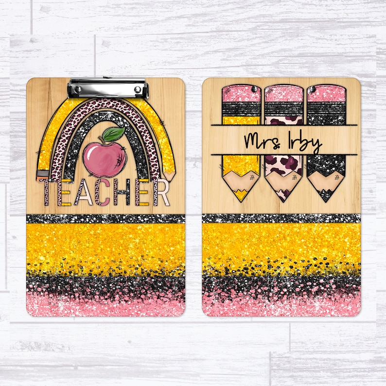 May include: A wooden clipboard with a gold glitter background and a rainbow with a red apple and pencils. The text "TEACHER" is on the clipboard. The other side of the clipboard has three pencils with a gold glitter background and the text "Mrs. Irby".