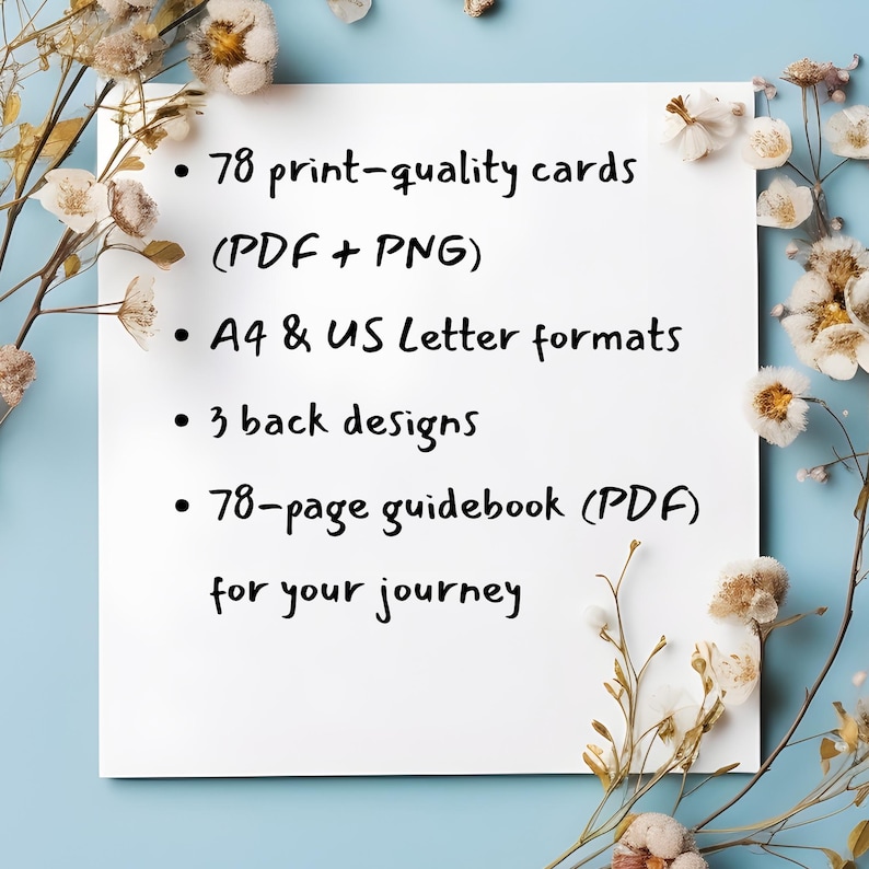 May include: A white rectangular card with black text listing product features: 78 print-quality cards, A4 & US Letter formats, 3 back designs, and a 78-page guidebook. The card is surrounded by dried flowers on a light blue background.