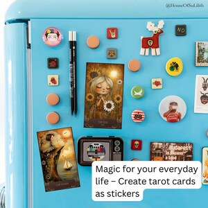 May include: A collection of decorative magnets and stickers on a light blue refrigerator. The items include tarot cards, a deer, a Frida Kahlo magnet, and other colorful designs. The text on the image reads "Magic for your everyday life - Create tarot cards as stickers."