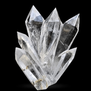 May include: A cluster of clear quartz crystals against a black backdrop. The crystals are transparent with sharp, pointed tips, and varying sizes. The quartz formation has a natural, raw appearance, showcasing its crystalline structure.
