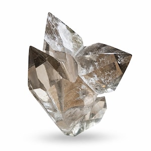 May include: A cluster of clear quartz crystals with sharp, pointed terminations. The crystals have a smoky, translucent appearance with subtle brown and grey hues. The overall shape is geometric and angular, with a natural, raw aesthetic.