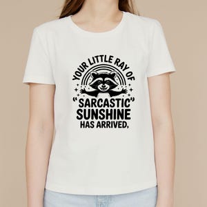 Sarcastic Funny,raccoon quote svg,sarcastic quote svg,Sarcastic Funny SVG,sassy raccoon svg,trendy raccoon svg,your little ray svg,sassy raccoon,sarcastic raccoon,raccoon sarcastic,sublimation raccoon,raccoon quote,sarcastic sunshineYour little ray of sarcastic sunshine svg, Sarcastic svg, Has arrived svg, funny raccoon svg, sassy raccoon , trendy design sublimation PNG
Your Little Ray Of Sarcastic Sunshine Has Arrived SVG PNG, Retro Funny Raccoon Shirt Design, Sarcastic Svg, Sassy Meme