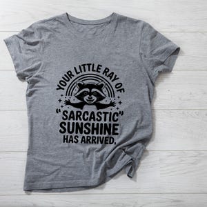 Sarcastic Funny,raccoon quote svg,sarcastic quote svg,Sarcastic Funny SVG,sassy raccoon svg,trendy raccoon svg,your little ray svg,sassy raccoon,sarcastic raccoon,raccoon sarcastic,sublimation raccoon,raccoon quote,sarcastic sunshineYour little ray of sarcastic sunshine svg, Sarcastic svg, Has arrived svg, funny raccoon svg, sassy raccoon , trendy design sublimation PNG
Your Little Ray Of Sarcastic Sunshine Has Arrived SVG PNG, Retro Funny Raccoon Shirt Design, Sarcastic Svg, Sassy Meme