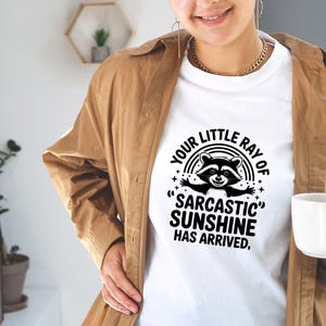 Sarcastic Funny,raccoon quote svg,sarcastic quote svg,Sarcastic Funny SVG,sassy raccoon svg,trendy raccoon svg,your little ray svg,sassy raccoon,sarcastic raccoon,raccoon sarcastic,sublimation raccoon,raccoon quote,sarcastic sunshineYour little ray of sarcastic sunshine svg, Sarcastic svg, Has arrived svg, funny raccoon svg, sassy raccoon , trendy design sublimation PNG
Your Little Ray Of Sarcastic Sunshine Has Arrived SVG PNG, Retro Funny Raccoon Shirt Design, Sarcastic Svg, Sassy Meme