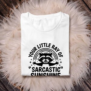 Sarcastic Funny,raccoon quote svg,sarcastic quote svg,Sarcastic Funny SVG,sassy raccoon svg,trendy raccoon svg,your little ray svg,sassy raccoon,sarcastic raccoon,raccoon sarcastic,sublimation raccoon,raccoon quote,sarcastic sunshineYour little ray of sarcastic sunshine svg, Sarcastic svg, Has arrived svg, funny raccoon svg, sassy raccoon , trendy design sublimation PNG
Your Little Ray Of Sarcastic Sunshine Has Arrived SVG PNG, Retro Funny Raccoon Shirt Design, Sarcastic Svg, Sassy Meme