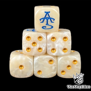 May include: A stack of six ivory-colored dice with gold pips. One die features a blue symbol. The dice are arranged in a pyramid shape against a black background. The dice are for tabletop games.