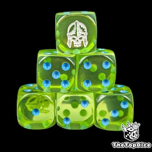 May include: A stack of six translucent green dice. Each die has blue and green dots, with one die featuring a silver skull and helmet design. The dice are arranged against a black background.