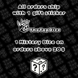 May include: Black background with white text and graphics. The text reads "All orders ship with 1 gift sticker" and "1 Mistery Dice on orders above 20&pound;". The logo "TheTopDice" is also displayed.
