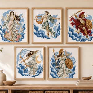 May include: Five framed cross-stitch artworks depicting Greek mythological figures. Each piece features a character surrounded by blue clouds, including a figure with a lyre, a warrior with a spear and shield, an archer, and two goddesses.