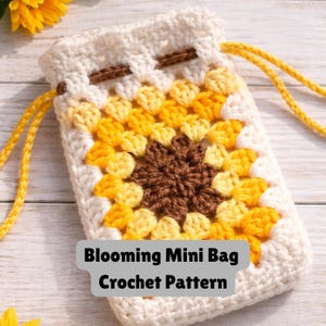 May include: A handmade crochet mini bag with a sunflower design. The bag features a drawstring closure and a pattern of brown, yellow, and cream-colored squares. The text "Blooming Mini Bag Crochet Pattern" is displayed on the front.