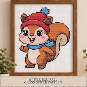 May include: A framed cross stitch pattern featuring a cartoon squirrel with brown fur, a white belly, and a large bushy tail. The squirrel wears a red winter hat with a blue pom-pom and a blue scarf. The text reads WINTER SQUIRREL CROSS STITCH PATTERN.