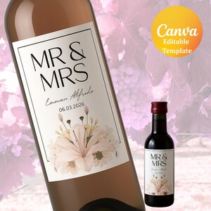 May include: A wine bottle and a miniature bottle with matching labels. The labels read "MR & MRS" above the names "Emman Alfredo" and the date "06.03.2026". The labels feature floral illustrations in soft pink and cream colors. The image also includes a "Canva" logo.