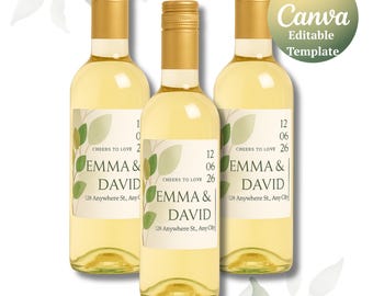 May include: Three bottles of white wine with gold caps and personalized labels. The labels feature the names "EMMA & DAVID", a date, and the text "Cheers to Love". The Canva Editable Template logo is in the upper right.