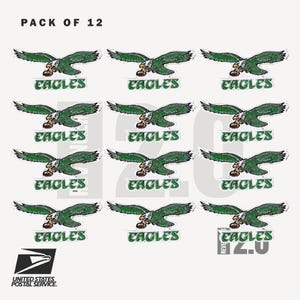 May include: A pack of 12 stickers featuring the Philadelphia Eagles logo. Each sticker shows a green eagle in flight, clutching a football, with the word "EAGLES" below. The United States Postal Service logo is also visible.