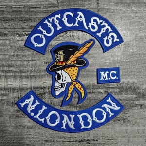 May include: Embroidered patches featuring a skull wearing a top hat and bandana, with the text "OUTCASTS" and "ALL LONDON" in white on blue arched backgrounds. A small patch reads "M.C."