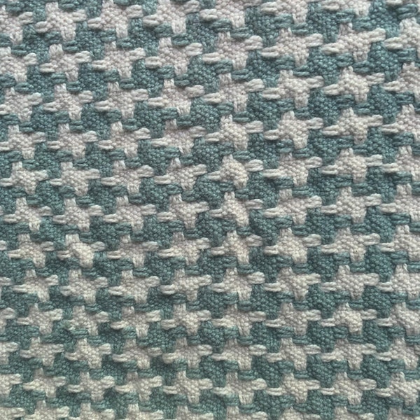 Green houndstooth upholstery fabric piece