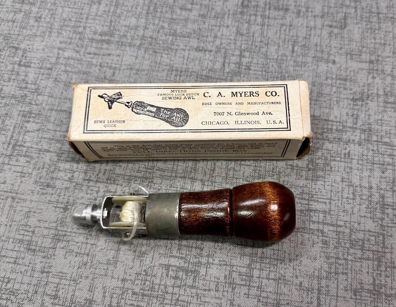 Myers sewing awl with original box, includes one needle, one wrench/screwdriver tool, one needle threader. Good condition. $15