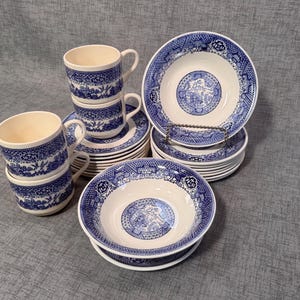 May include: A set of blue and white china dishes with a willow pattern. The set includes cups, saucers, and bowls.