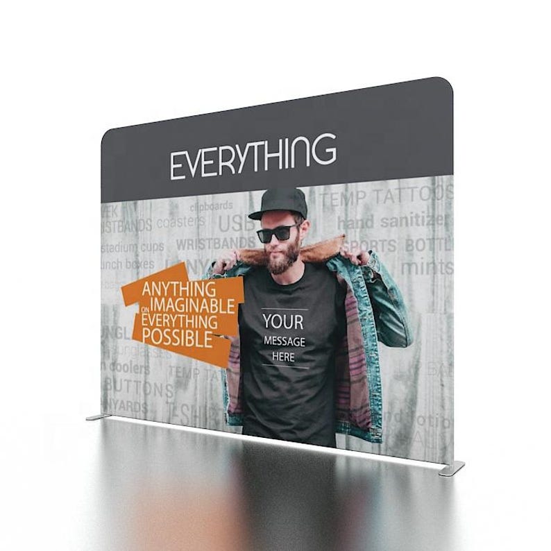 May include: A black and white graphic design with the text "EVERYTHING" in large white letters. The text "ANYTHING IMAGINABLE EVERYTHING POSSIBLE" is in orange letters on a black background. The text "YOUR MESSAGE HERE" is on a black t-shirt worn by a person in the image.