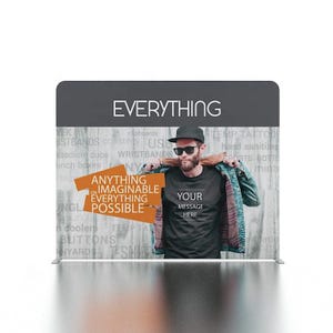 May include: A gray fabric backdrop with the word "EVERYTHING" printed in white. The backdrop features a man wearing a black t-shirt with the text "YOUR MESSAGE HERE" printed in white. The backdrop also features the text "ANYTHING ON IMAGINABLE EVERYTHING POSSIBLE" printed in orange.