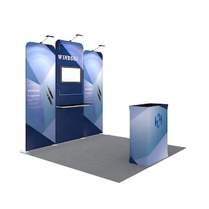 May include: A trade show booth with a blue and white geometric design. The booth features the text "WINDSHI" and "e-cigarette". A monitor is mounted on the center panel. A small counter and a podium are also present.