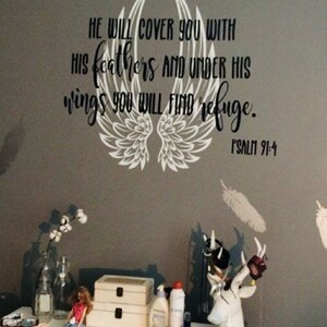 May include: A white vinyl decal with a pair of angel wings and the text "HE WILL COVER YOU WITH HIS FEATHERS AND UNDER HIS WINGS YOU WILL FIND REFUGE. PSALM 91:4"