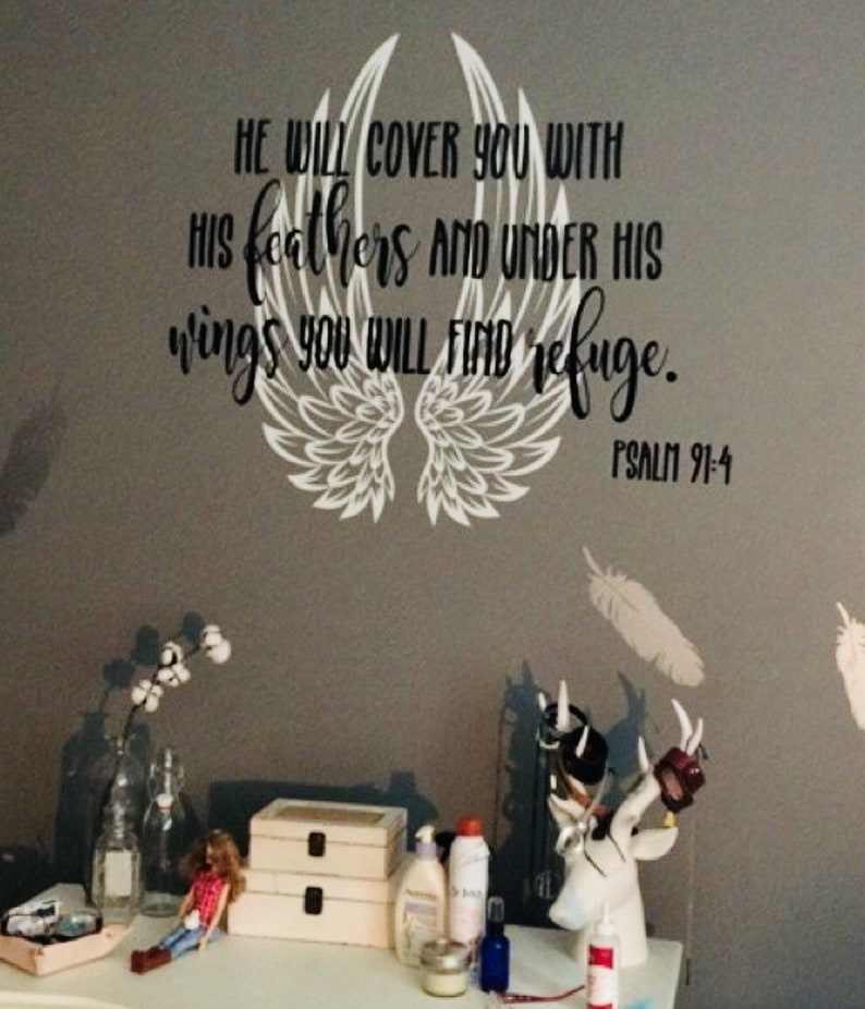May include: A white vinyl decal with a pair of angel wings and the text "HE WILL COVER YOU WITH HIS FEATHERS AND UNDER HIS WINGS YOU WILL FIND REFUGE. PSALM 91:4"
