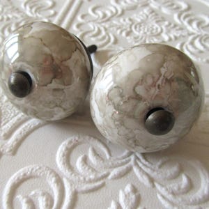 Set of 2 Glazed White and Tan Ceramic Knobs with Aged Brass Centers