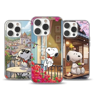 May include: Three clear phone cases with Snoopy designs. One depicts Snoopy on a balcony overlooking a town, another with a hummingbird, and the third in a Japanese scene with cherry blossom trees.