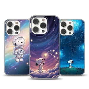 May include: Three phone cases featuring Snoopy designs. One case shows Snoopy in an astronaut suit against a galaxy backdrop. Another depicts Snoopy painting stars in a night sky. The third case shows Snoopy gazing at a starry night.